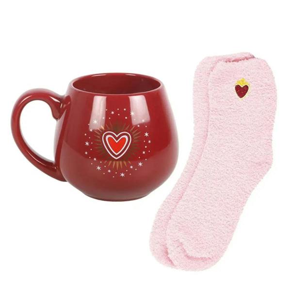 Red heart-pattern mug with fuzzy rim and light pink fuzzy socks with a small heart.