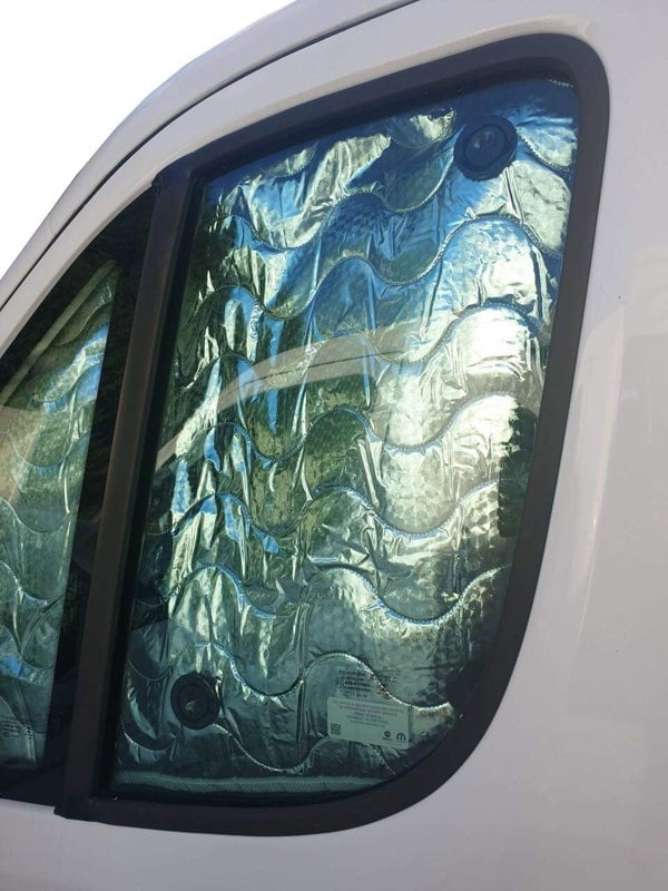 The side cab windows of the OLPRO Universal Internal Thermal Motorhome Blind on a Fiat Ducato on a white background.