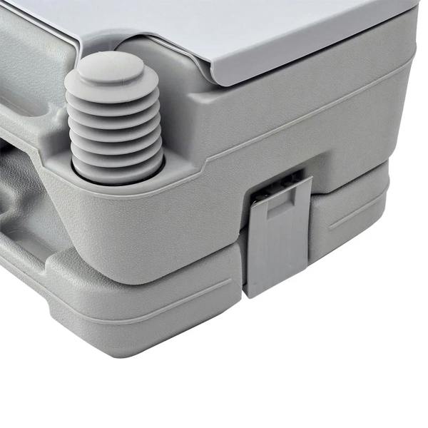 Grey portable toilet close-up of flush pump stack and slide valve panel