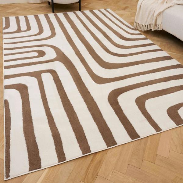 Brown and white patterned rug on a wooden floor