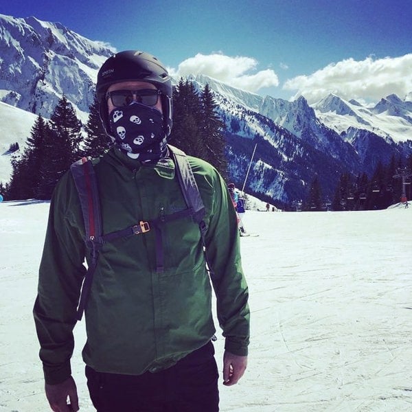 Person in green jacket and helmet wearing a Ruffnek skull pattern snood scarf face mask on a snowy mountain skiing. 
#SkiingFashion #SkiingAdventures #SkiingLife #TravelScarf #SkiSnood