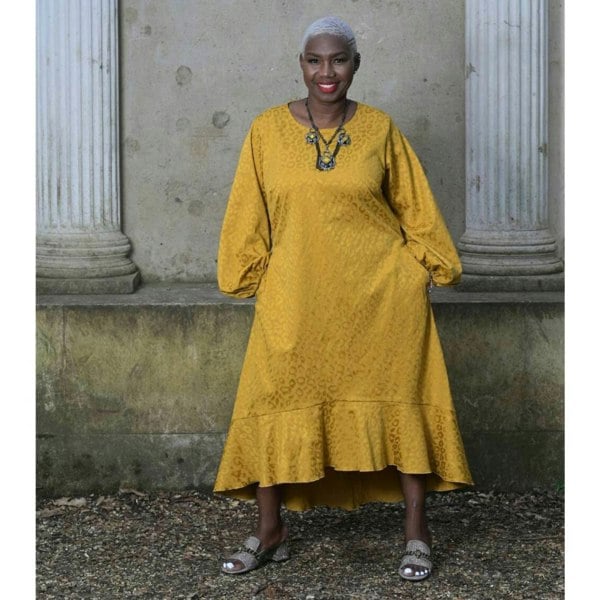 Women's Plus Size Gold Aphrodite Leopard Jacquard Dress with pockets styled with a yellow stone necklace and gold Kurt Geiger sandals for an elegant look.