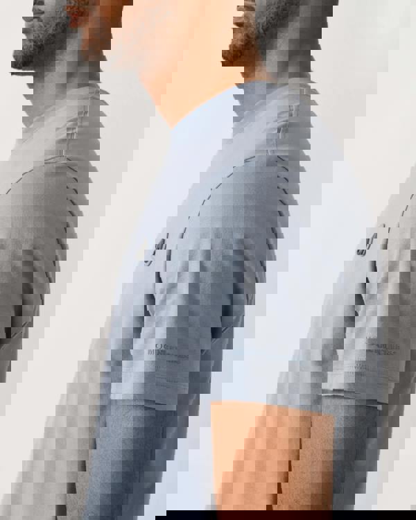 logo shot of a model wearing a Moose Knuckles Crescent Mens T-Shirt in Jet Stream 1884