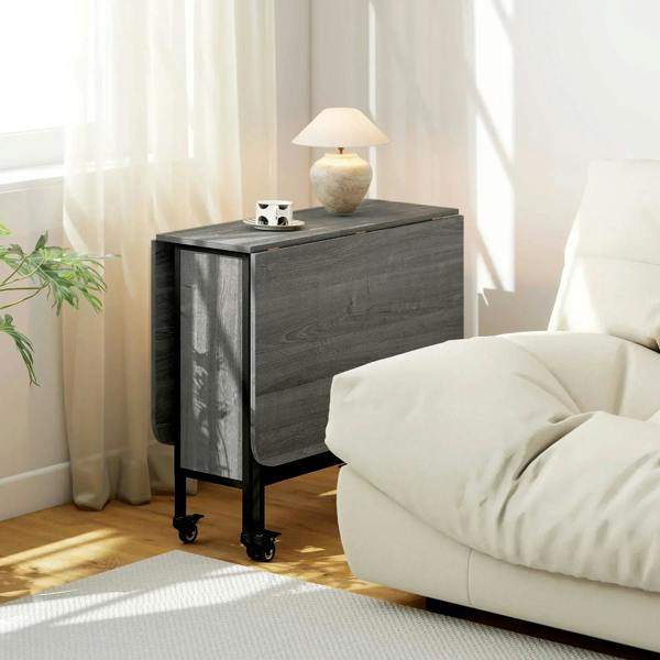 Grey drop-leaf dining table with black frame, closed cabinet sides, and caster wheels