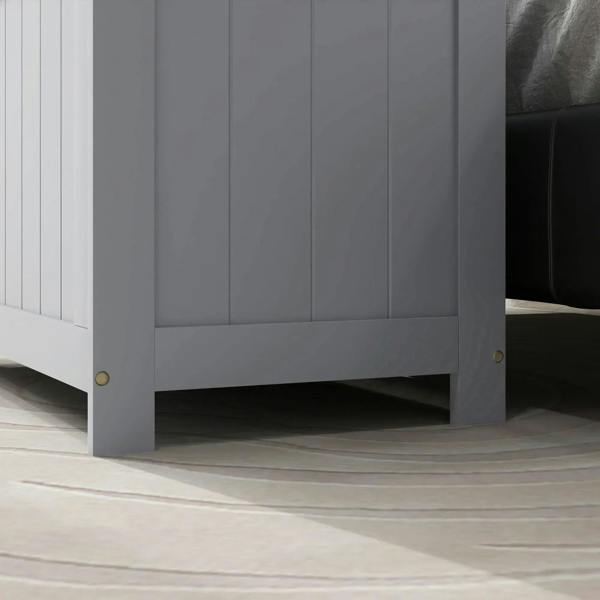 Grey storage chest corner view with vertical panels and brass-toned feet