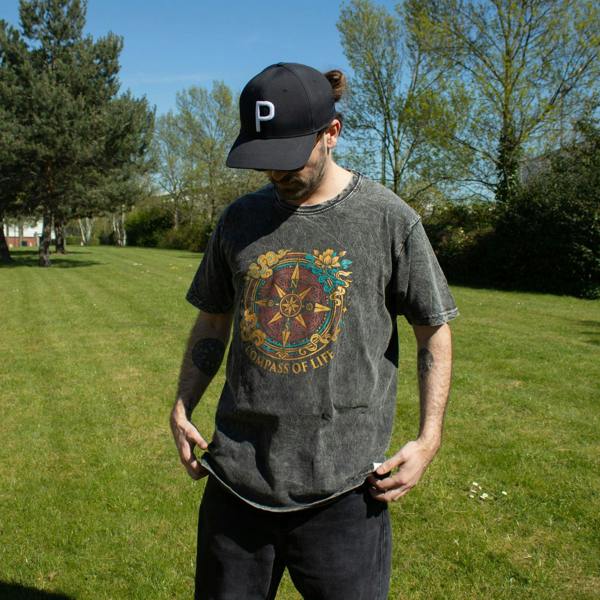 Charcoal stonewashed cotton T-shirt with front Compass of Life design on a standing model
