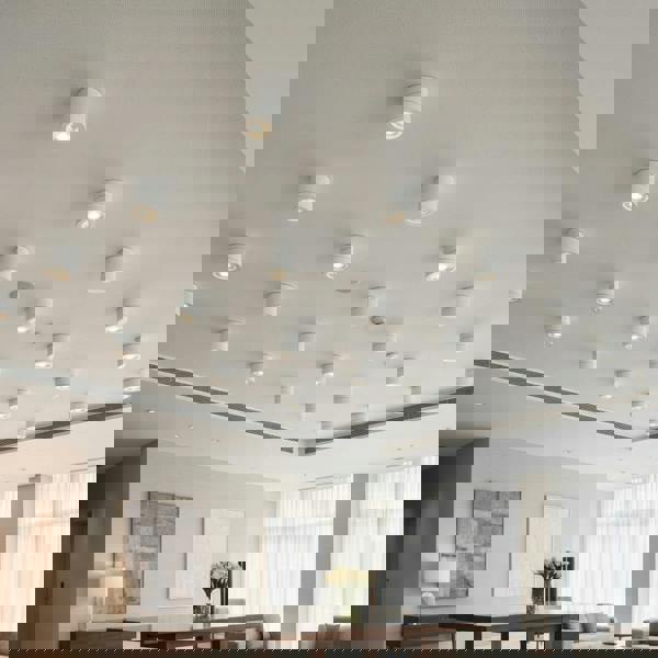 white surface mount adjustable spotlight mounted on the ceiling in a hotel reception area