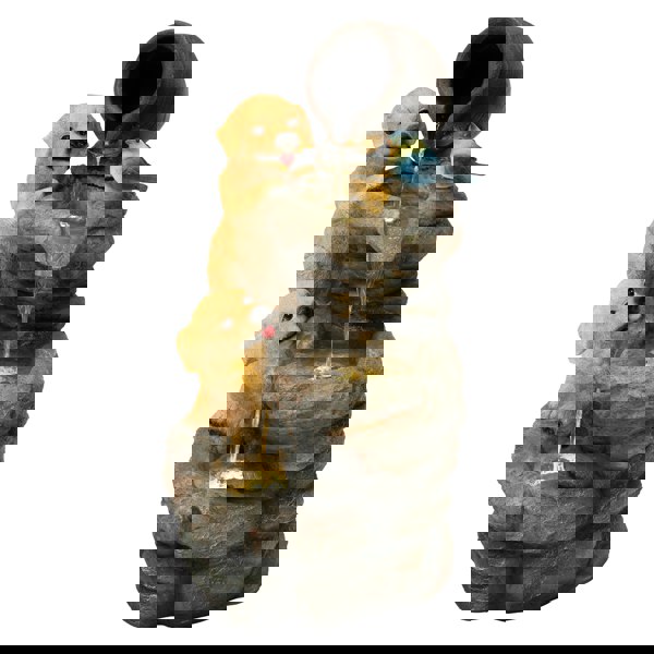 Electric water feature with two playful golden retriever puppies, a bluebird, and cascading water over textured stone-like tiers