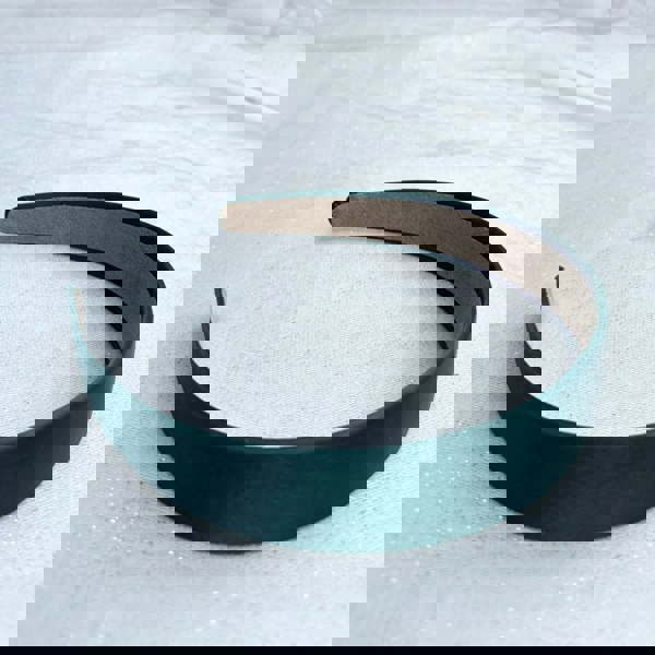 Dark green hairband, smooth satin finish, padded structure, rich deep green colour, minimalist classic design, versatile everyday accessory
