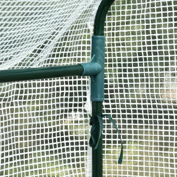 Walk-in greenhouse frame corner with dark green pole and mesh cover attachment
