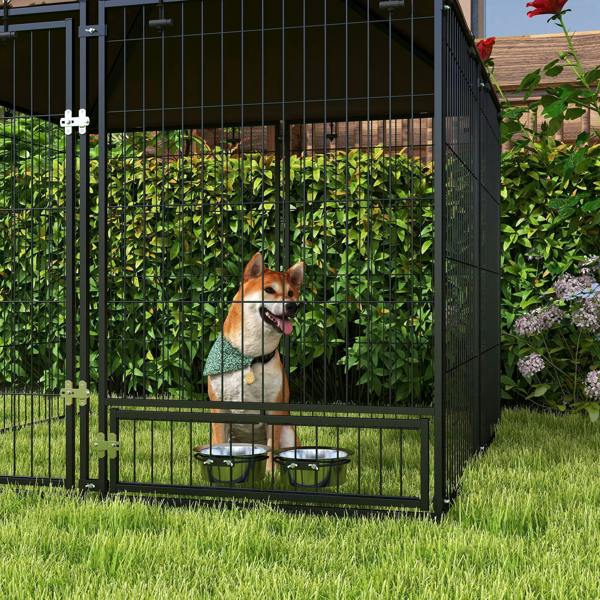 Outdoor dog playpen kennel with two bowls inside and black wire fence panels
