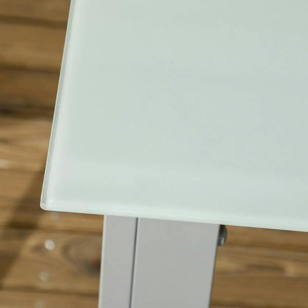 Tempered glass tabletop corner with grey aluminum frame on outdoor dining table.