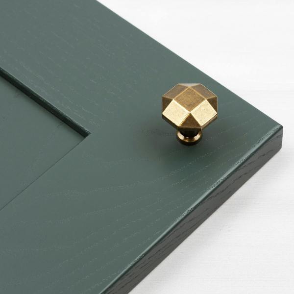 A 27mm diameter antique brass octagonal knob with a single hole fixing