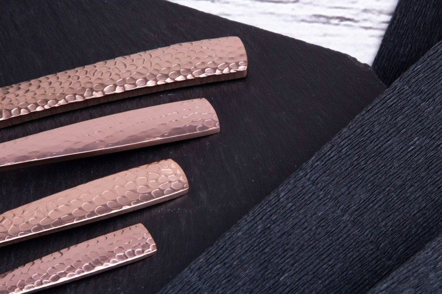 A detailed view showcasing the ornate handles of the BH/2617 Rose Gold Cutlery Set against a stylish background.