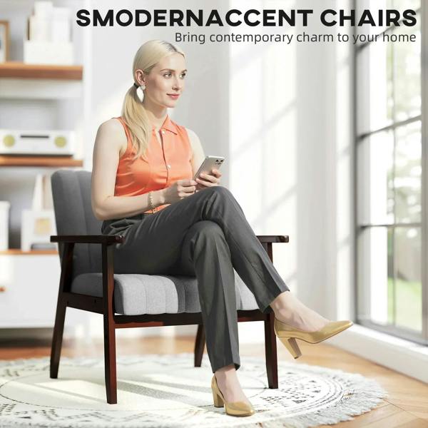 Grey accent chair with wooden legs, styled with a seated person