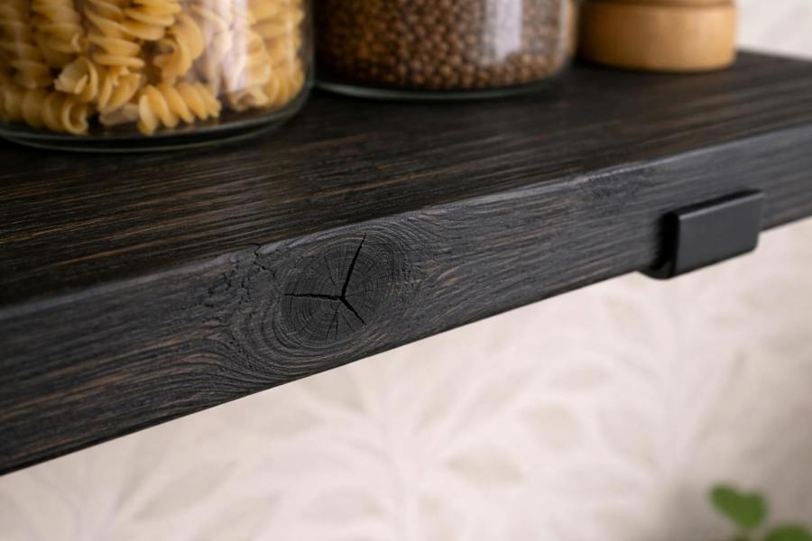 Close up of ebony stained reclaimed scaffold board showing grain and knot detail