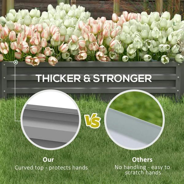 Light grey raised garden bed packed with pink and white tulip-like flowers