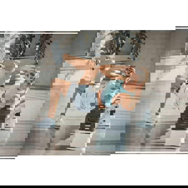 Woman using a Reebok Deck Home Abdominal Training - White