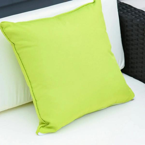 Lime green throw pillow on white outdoor sofa cushion