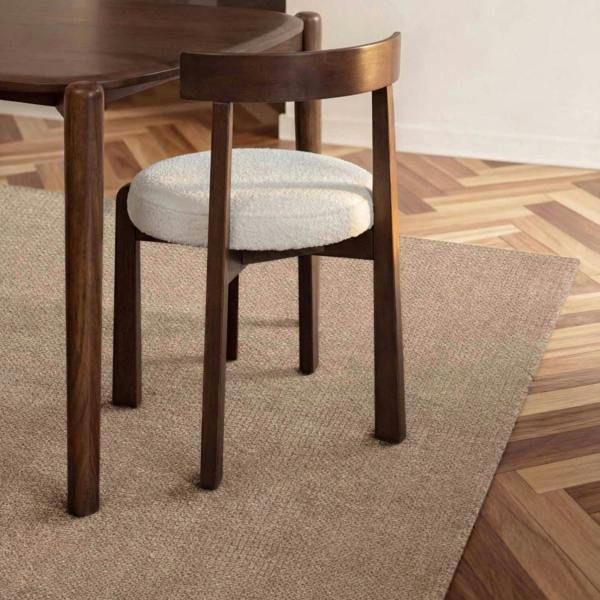 Wooden chair with a cushioned seat on a wooden floor