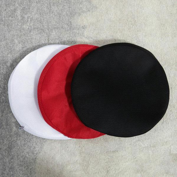 Two replaceable stool seat covers stacked: black and red with white cover