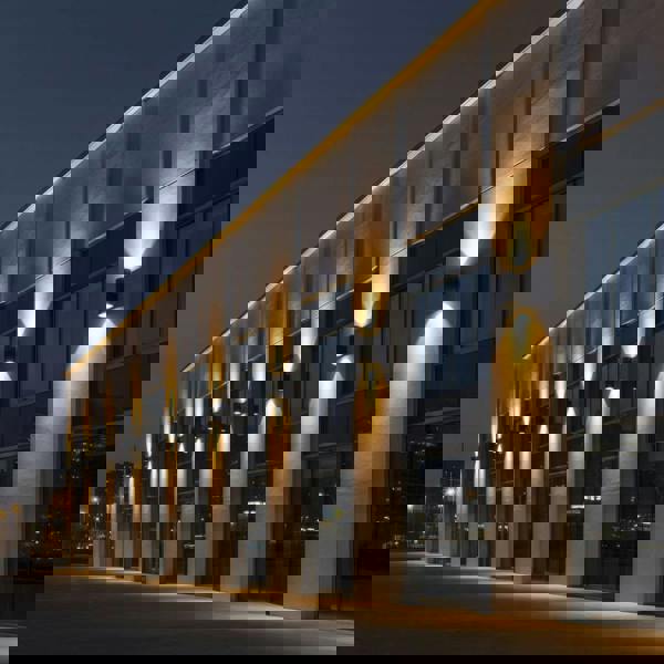 large exterior wall light showing a number of lights mounted along the wall of a large commercial building