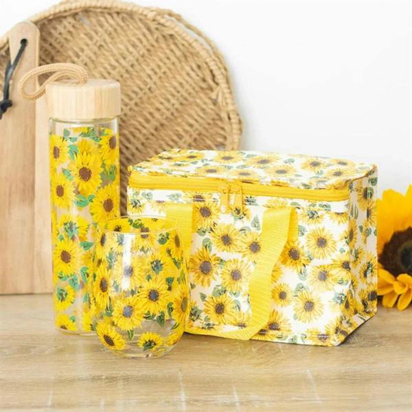 Sunflower print lunch bag with yellow zipper and carry handles, beside bottle