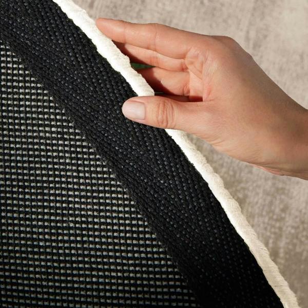 Hand holding a textured black and white fabric