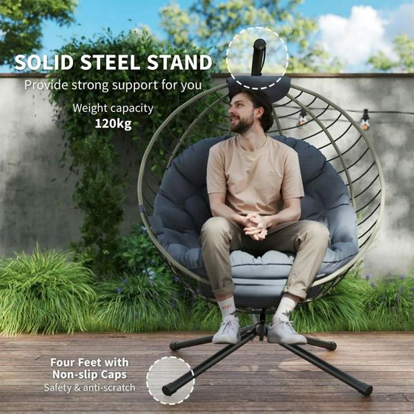 Grey hanging rattan swing chair with metal stand, four feet, and thick padded cushion