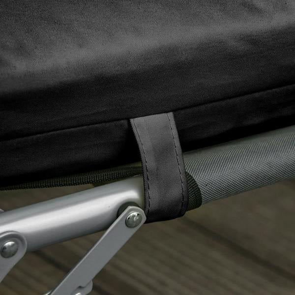 Black cushion tie band fastened around lounge chair frame bar