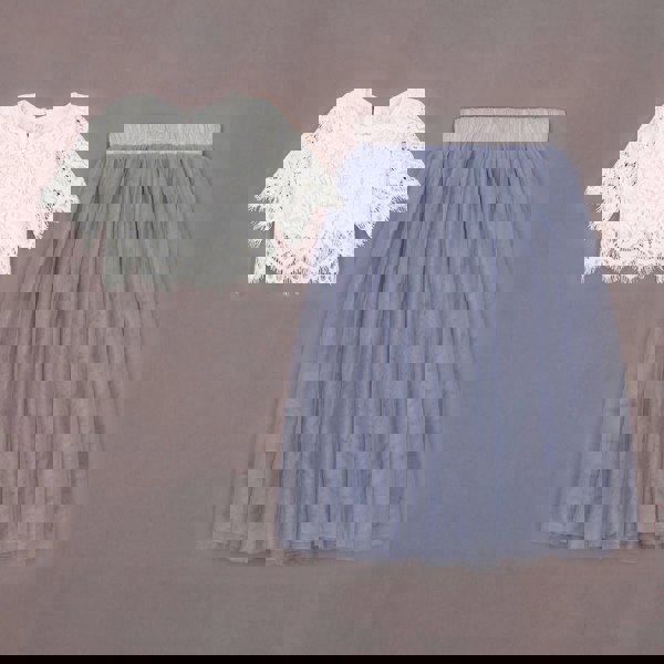 White lace top and blue tulle skirt on a brown background