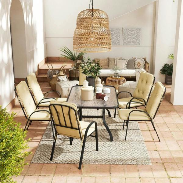 Beige cushioned outdoor dining set with six chairs and square tabletop on rug