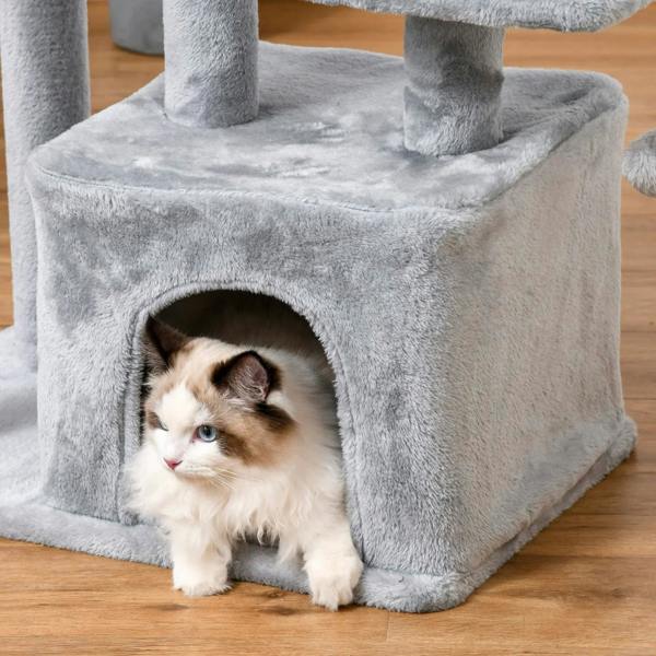 Light grey plush cat house on a cat tree tower with kitten inside