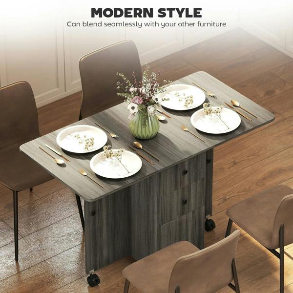 Grey drop-leaf dining table with drawers, casters, and place settings