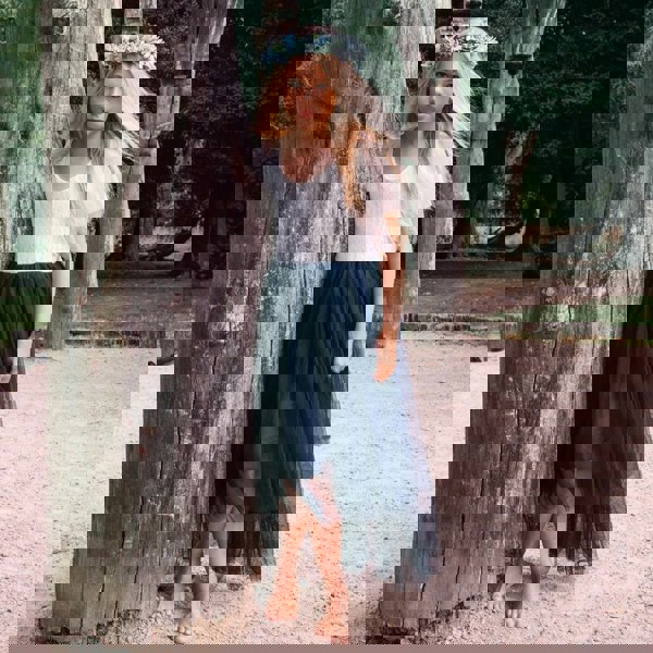 young girl wearing a navy blue flower girl dress