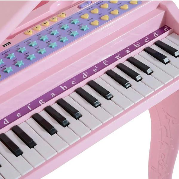 Pink keyboard keybed with colorful buttons, dark keys, and letter note strip