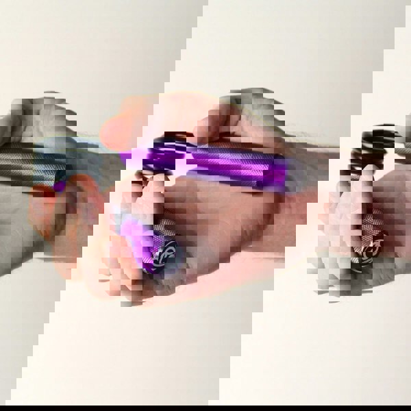 Man gripping a purple Fitness Mad Pro Power Hand Grip - 90kg Resistance