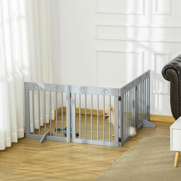 Grey folding wooden pet gate with vertical bars, paw print tops, and stand on support feet