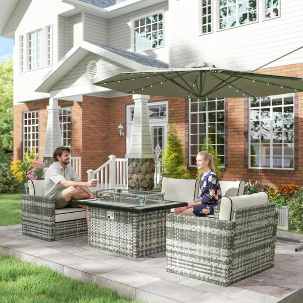 Grey rattan patio furniture set with fire pit table and loveseat seating on a terrace
