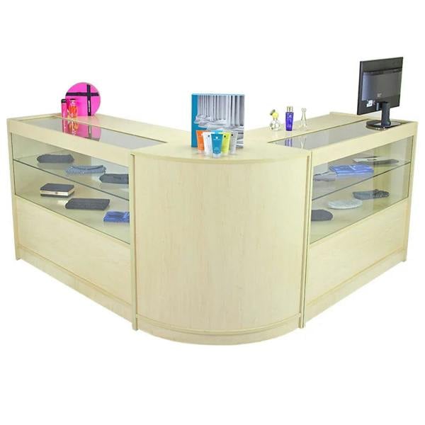 Curved maple reception desk with glass display shelves, showcasing colorful items and a monitor, ideal for modern office spaces