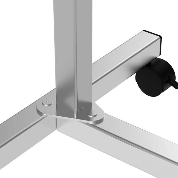 Black caster wheel with brake attached to silver frame for over-bed table