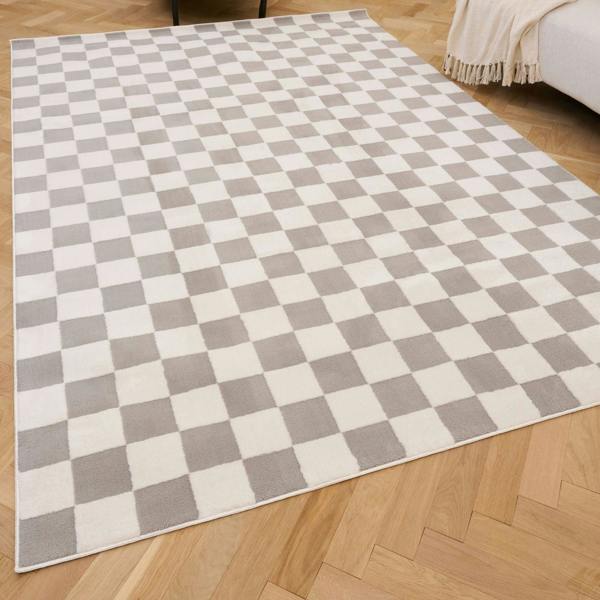 Checkered rug with gray and white squares on a wooden floor