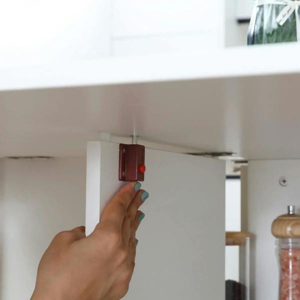 White table fold/lock latch mechanism near the edge underside