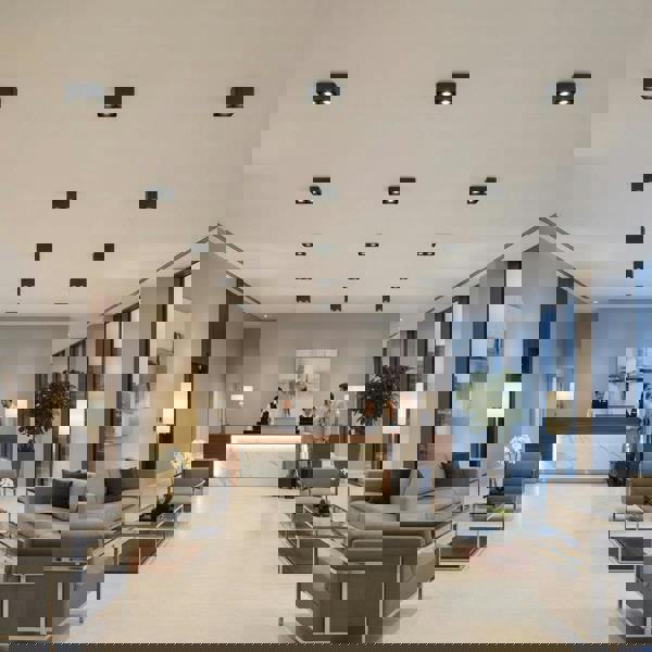 black ceiling light fixture mounted on the ceiling of a hotel reception