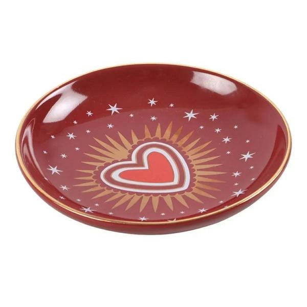 Red oval trinket dish with gold rim, white sacred heart icon with sunburst