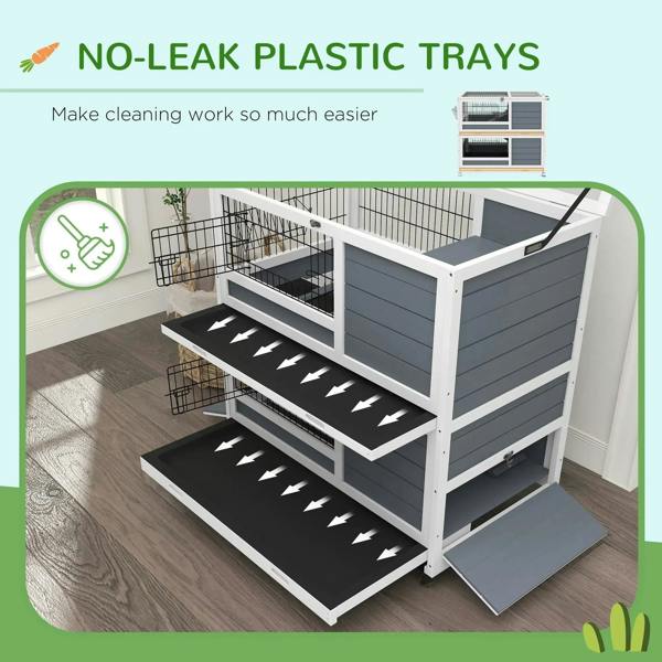 Grey double-decker cage with stacked plastic trays and ramp steps inside