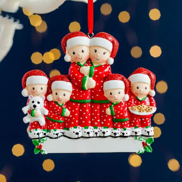 Personalised resin Christmas tree decoration featuring a family of six in matching red and white pyjamas, hung against a blurred festive background.