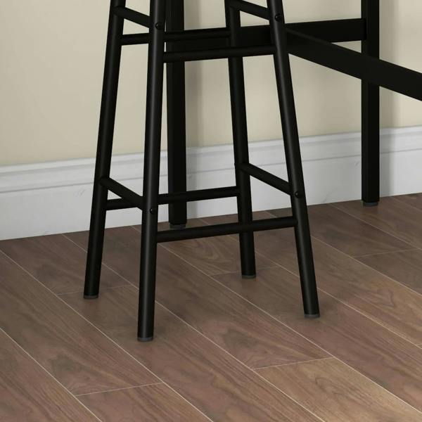 Close-up of industrial bar stool legs and cross-brace frame with black metal feet