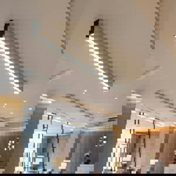 silver slim surface downlight mounted on the ceiling in a hotel reception