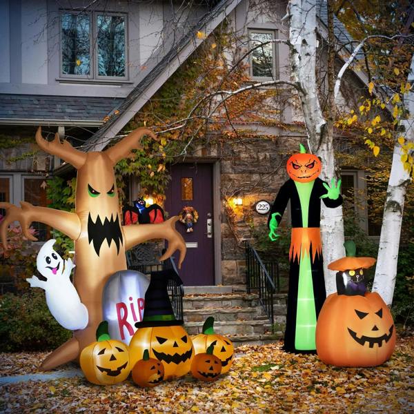Inflatable jack-o'-lantern pumpkin set with witch hat in outdoor yard scene